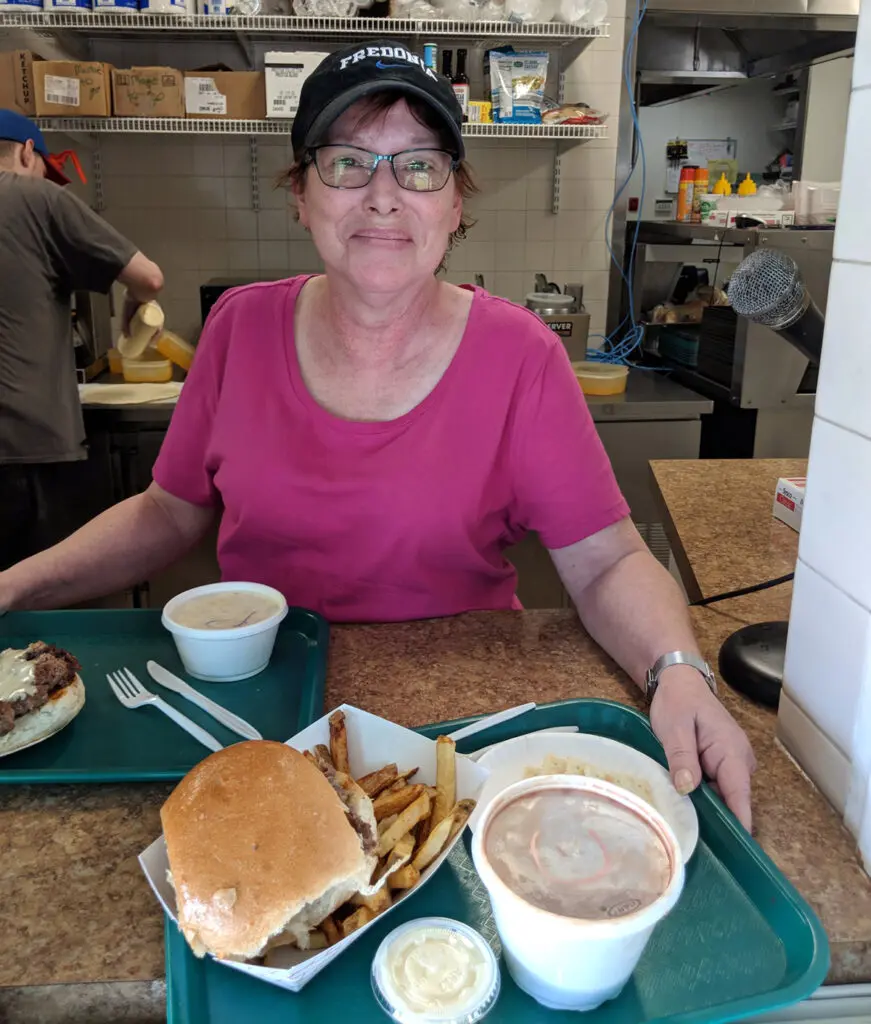 Dawn Zagurski, owner of Sam'z handing food on tray thru window